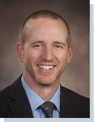 A man wearing a suit and tie is smiling for the camera. AI generated content